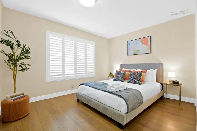 Bed with a grey frame and a floral print