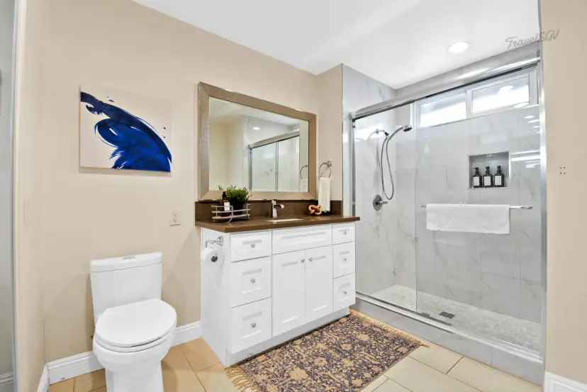 Bathroom with a walk-in glass shower and white vanity
