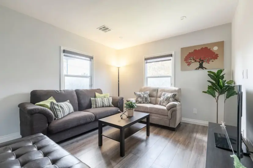 Living room with brown sofas and a wall TV