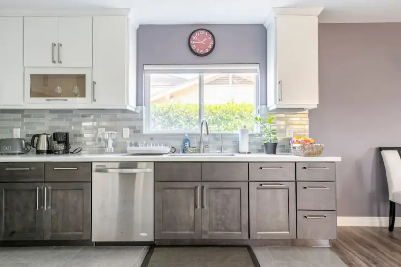 Two-tone kitchen with a dishwasher and a window
