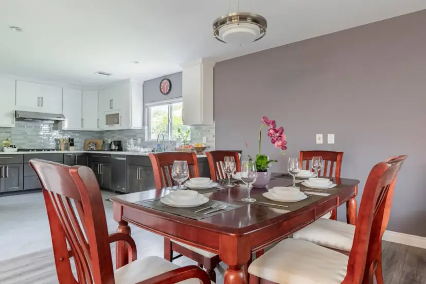 Dining table set for the group with the kitchen beyond