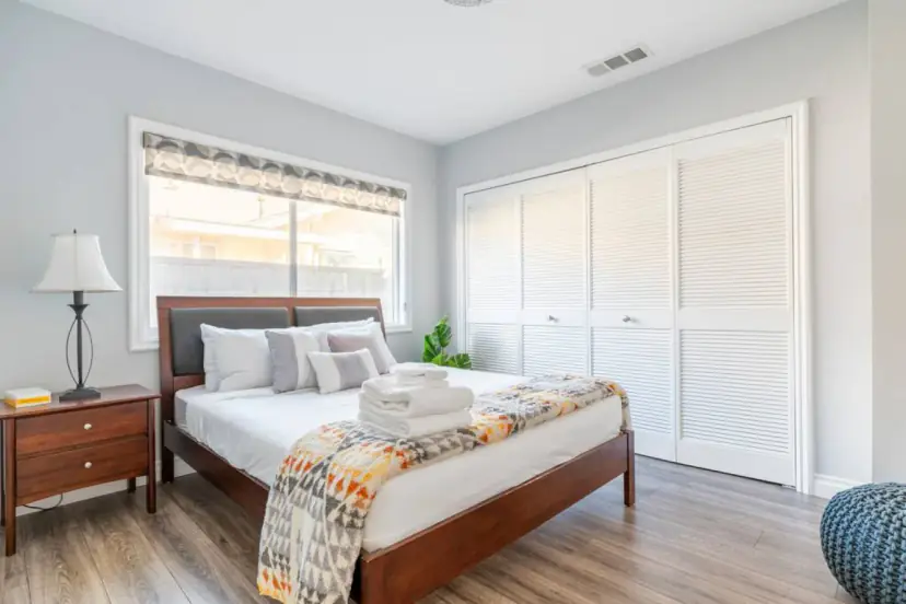 Bedroom with a wood bed and a closet wall