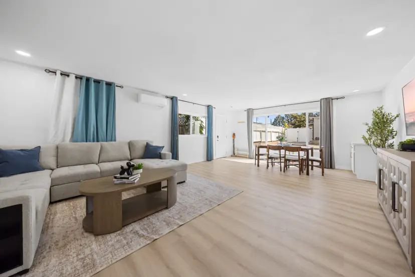 Downstairs living room with a sectional and dining