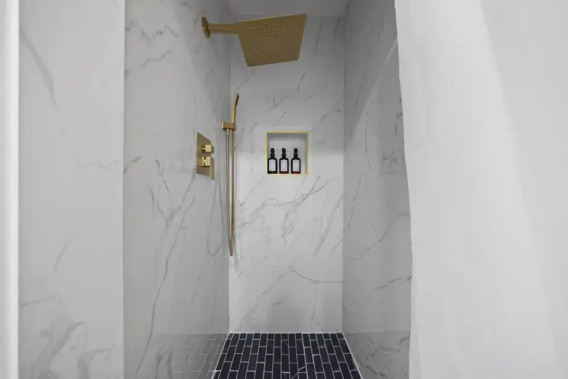 Marble-look shower with a gold rain head