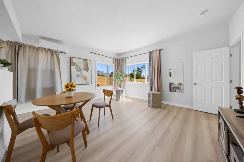 Round dining table by sunny windows upstairs