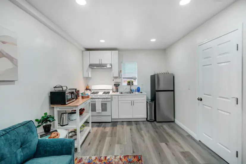 Kitchen with a white range, a stainless fridge and a butcher-block cart