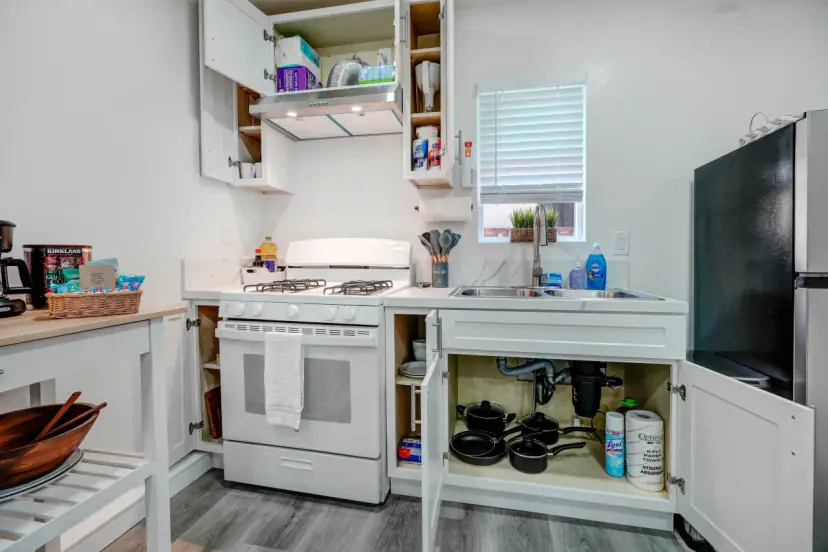 Kitchen with a white range and a stainless fridge