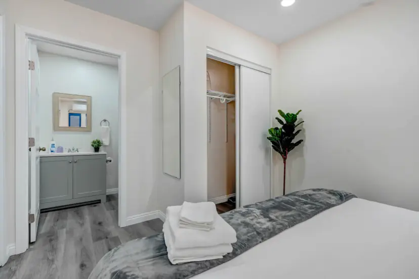 Bedroom with a closet and the bathroom beyond